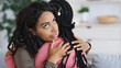 © Prostock-studio - Irritated black lady hugging her girlfriend with annoyed face expression, fake friendship concept. Two african american women embracing, crying lady looking for support, copy space