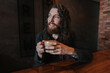 © ADDICTIVE STOCK - Man enjoying coffee while sitting at a cozy cafe