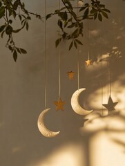 Fototapete - Softly glowing moon and stars mobile casting delicate shadows on a wall during twilight