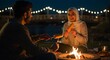 © fantastic - Traditional Middle Eastern Couple Gathering Around Campfire at Night