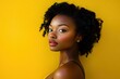 © Farzana - Close-up studio portrait of beautiful young Black woman on bright yellow background