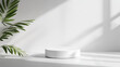 © Watcharin - A white pedestal with a leafy plant in front of it