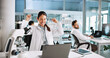 © peopleimages.com - Woman, scientist and celebration with fist pump in lab with medical research, cheers or success. Person, equipment and clinical study for vaccine with goals, dna and laptop for pharmaceutical trial