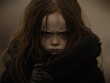 © Sosmedia - Sad Little Girl with Brown Hair and Freckles in Gritty Portrait with a Misted Background Wearing Black Clothing and Gloves
