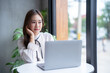 © Thinapob - asian freelance people business female talking making using casual working with laptop computer for browsing internet, chatting and blogging and smartphone,notebook in coffee shop.