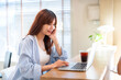 © Thinapob - Portrait of asian freelance teenage people business woman casual working with laptop computer in cafe interior in coffee shop background,business expressed confidence embolden and successful concept
