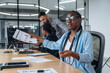 © standret - African American woman is sitting by table. Business people are working in the office