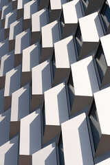Facade pattern of white cubic modules with geometric repetition and strong light contrast