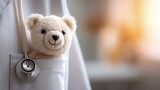 A friendly teddy bear peeks out of a doctor's pocket, symbolizing comfort and care.