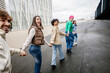 © Xavier Lorenzo - Diverse group of young friends running happily together while holding hands. Youth community, friendship and unity concept
