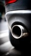 © Nataliya - Close-up of a car exhaust pipe showcasing its metallic finish and design