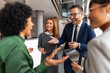 © Jelena - Group of Colleagues Engaged in a Professional Conversation During a Meeting