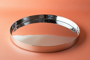 Poster - Reflective metal tray on a smooth orange background highlighting its design and glossy finish