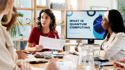 Meeting, business and women talk in office for planning, ideas and quantum computing solution. People, presentation and brainstorming with proposal documents, programming information and server tips