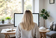 © Родион Бондаренко - young female freelancer sitting at table at home in front of monitor, monitor mockup, rear view