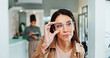 © peopleimages.com - Eye care, woman and glasses choice in mirror for frame shopping, prescription lens size and eyewear fitting. Mature person, eyesight and check for vision correction and optical health in retail store