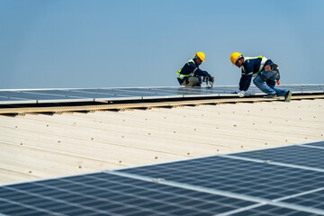Wall Mural - team of professionals installs solar panels, ensuring energy efficiency and sustainable development.