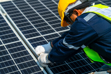 Wall Mural - two engineers install solar panels on a rooftop, wearing safety gear and helmets. the scene showcase