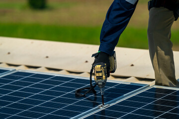 Wall Mural - two engineers install solar panels on a rooftop, wearing safety gear and helmets. the scene showcase