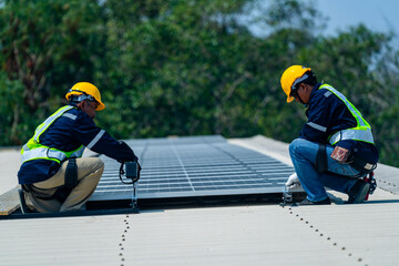 Wall Mural - two engineers install solar panels on a rooftop, wearing safety gear and helmets. the scene showcase