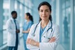 © Alexander Reitter - Confident Female Doctor in a Hospital Setting with Medical Colleagues