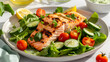 © Chanistha - Delicious grilled salmon atop fresh mixed greens, garnished with vibrant vegetables