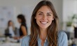 © Imagine Stuff - Smiling woman in office with colleagues working in background
