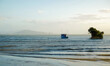 © Austockphoto - Solitary boat beside a mangrove by the beach