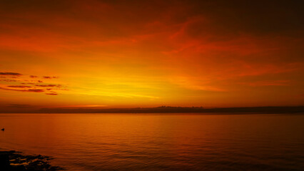 Wall Mural - stunning sunset over calm ocean waters