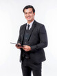 © suphaporn - A confident young businessman in a black suit and tie, holding a digital tablet and smiling against isolated on a transparent background, ready for modern business applications