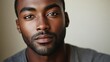 © Olena - Calm African American Man with Expressionless Face Posing Photogenically Against a Clean Copy Space