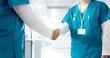 © CC/peopleimages.com - Handshake, medical and welcome with nurses in hospital for agreement, deal or partnership closeup. Collaboration, meeting and thank you with healthcare people shaking hands in hallway of clinic