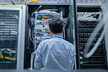 computer engineer is setting up network in server room,systems maintenance technician,male engineer 