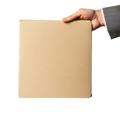 Hand holding a tan colored square object against a dark setting on transparent background