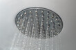 © Dorin - Shower head from a bathroom shower cabin ceiling with running hot water, soft focus close up with motion blur