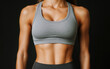 © Ai Stock Lab - Toned abs of female athlete in gray sports bra, showcasing strength and fitness. image captures dedication and hard work in fitness