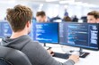 © Tida - Software Developer Working on Code - A programmer sits at his desk, focused on two computer screens displaying lines of code. He is working in a modern office environment