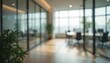 © miss irine - Abstract office interior background. Blurry office space. Modern workspace design. Glass walls, blurred furniture, plants. Natural light, commercial building, business concept, indoor.