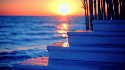 Wall Mural - sunset over the ocean, bamboo sticks in the foreground, trees in the background