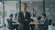 © all is well - A confident woman in a suit stands in front of a glass wall with a team working in the background