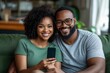 © olegganko - Joyful Couple Enjoying Their Time Together While Watching Something on a Smartphone in a Cozy Living Room