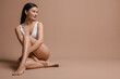 © New Africa - Woman in white underwear with smooth skin after epilation procedure on beige background, space for text