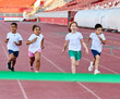 © Lumos sp - child sport athlete competition running race exercise sprinting speed runner achievement finish line celebration challenge champion goal ribbon success