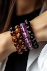 Poster - Charming display of colorful gemstone bracelets featuring tiger eye, amethyst and quartz on a model's wrist : Generative AI