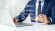 © mod - Businessman using laptop with digital checklist interface for task management and productivity