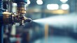 © Artify Shots - Close-up of industrial spray nozzle releasing a mist in a manufacturing facility, highlighting the shiny details of the metal and blurred background for a sense of depth