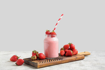 Wall Mural - Mason jar of tasty strawberry smoothie on table