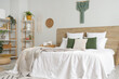 © Pixel-Shot - Interior of light bedroom with bed, shelf units and plants