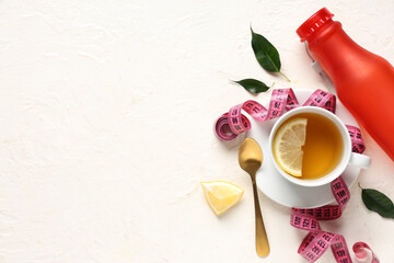 Wall Mural - Cup of diet tea, bottle with water, lemon and measuring tape on light background. Weight loss concept