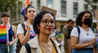 © Postmodern Studio - Mature hispanic woman at lgbtq+ pride parade with diverse participants